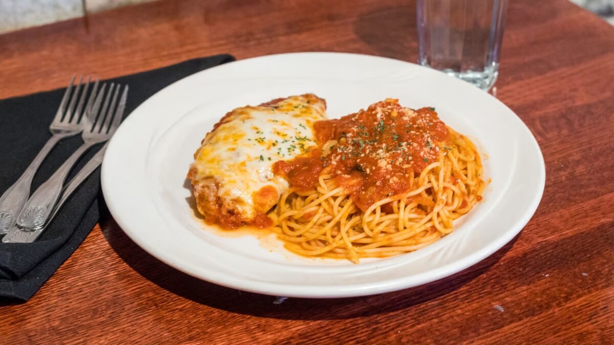 Chicken parmigiana over spaghetti with marinara at Ray's Italian Bistro