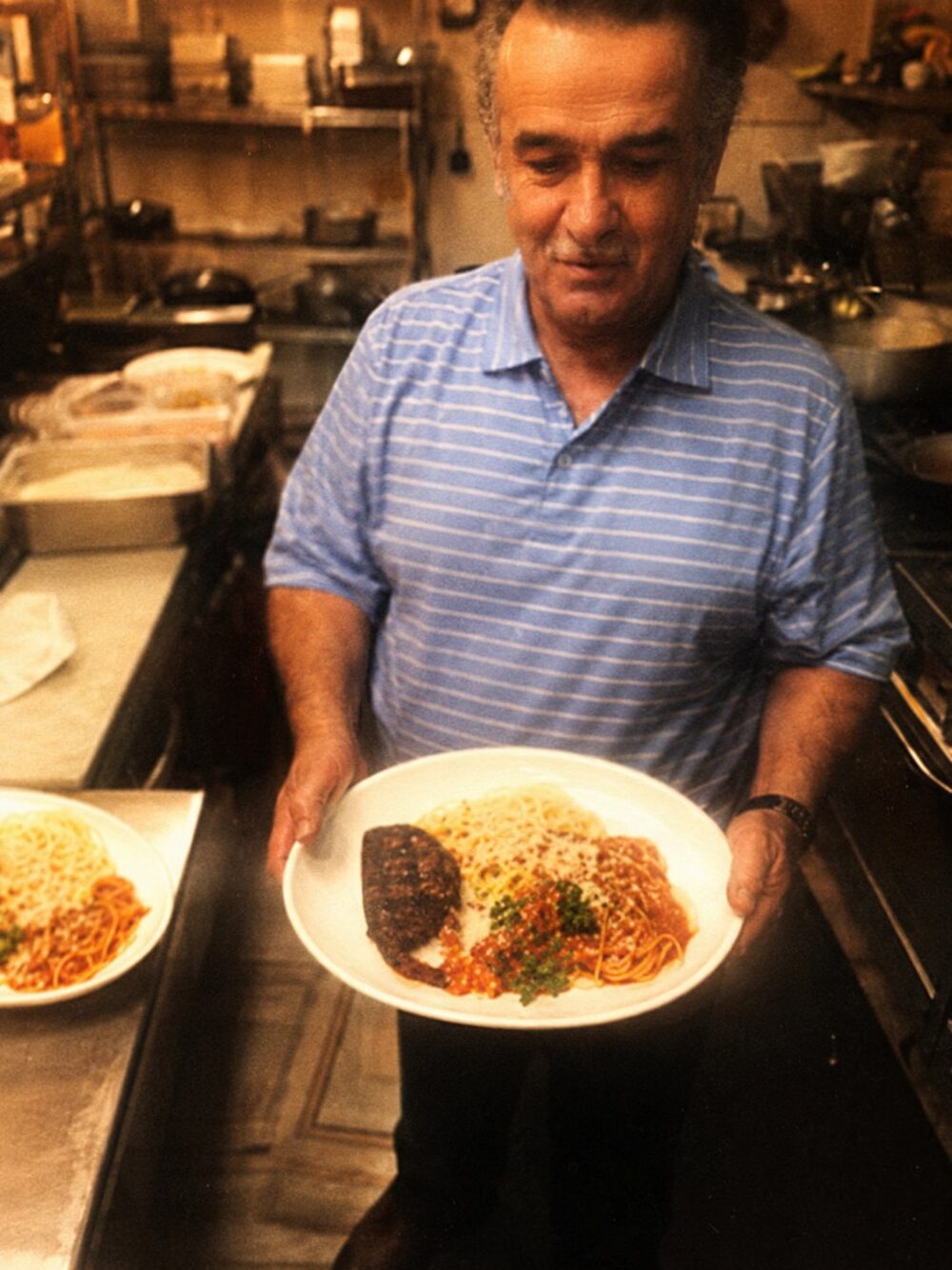 Ray plating dinner in the kitchen at Ray's Italian Bistro
